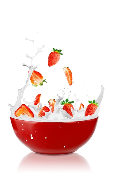 Strawberries falling into a fresh bowl of cream Healthy Breakfast milk and fresh berries vegetarian food