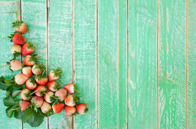 strawberries on green wooden floor