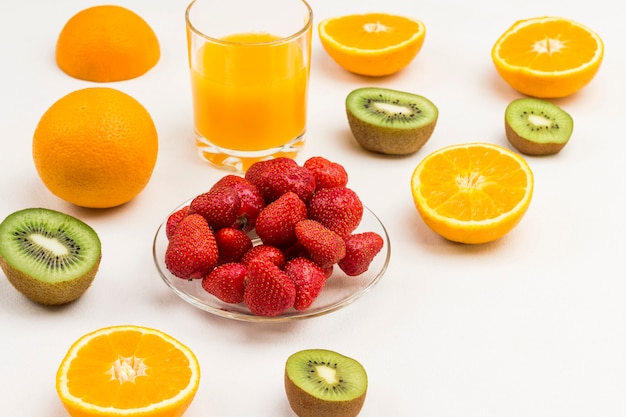 Strawberries, halves of orange and kiwi, orange juice.  Weight loss concept.