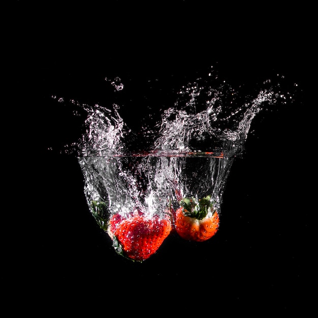 Strawberries plunging into the water