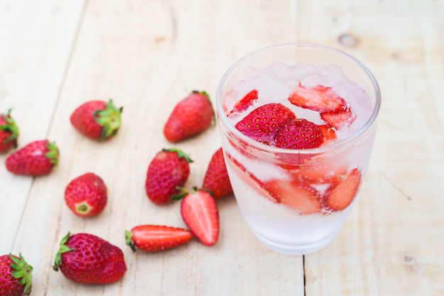 Strawberries soda on wood