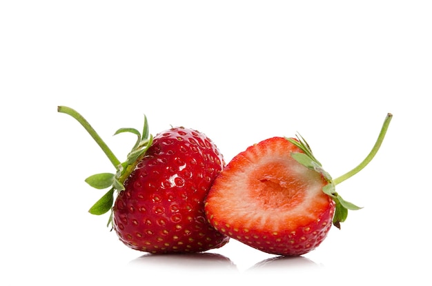 Strawberries whole one another half isolated on white backgraund