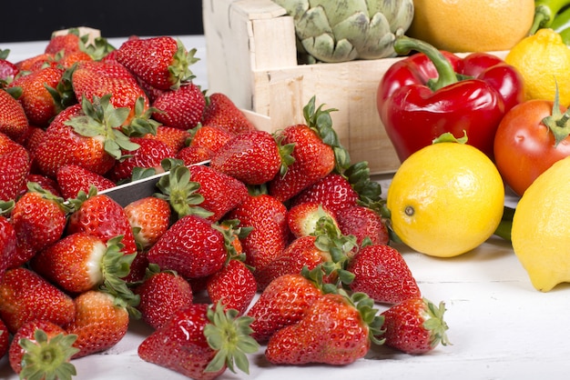 Strawberries with some fruits and Vegetables on table