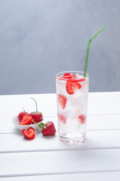 Strawberry alcohol cocktail on white wooden table