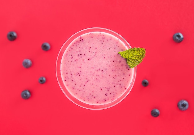 Strawberry and blueberry smoothie in a martini glass