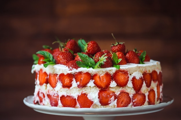 Strawberry cake on a wooden background.