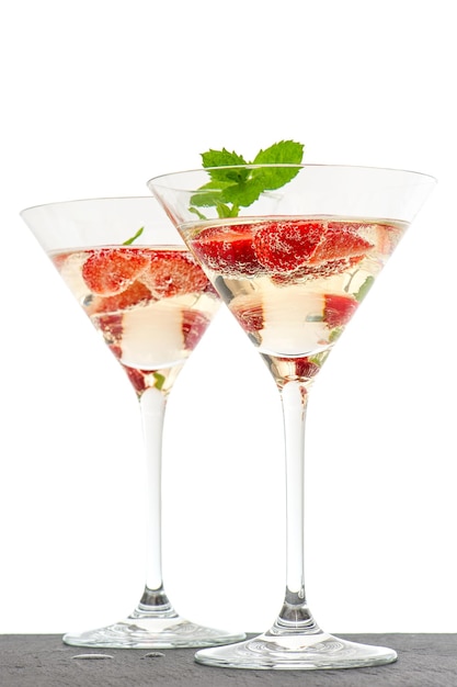 Strawberry cocktail with berry in martini glass isolated on white background. festive arrangement with sparkling wine and fresh berries. selective focus