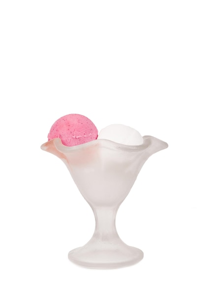 Strawberry and cream ice cream in a crystal glass on a white background