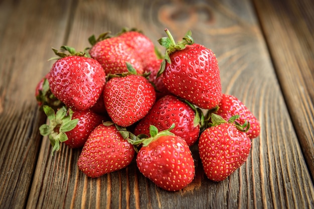 Strawberry on dark wooden background.