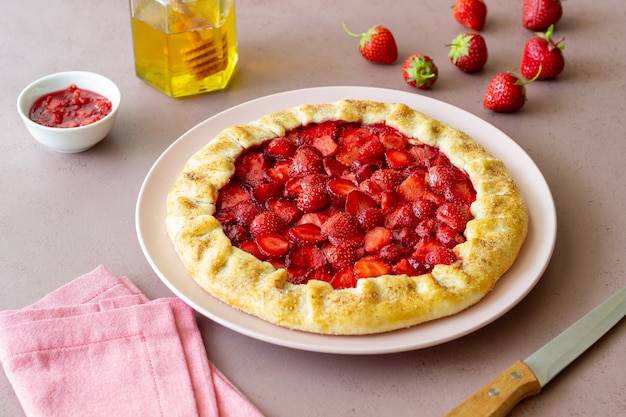 Photo strawberry galette or open pie . baking. vegetarian food.