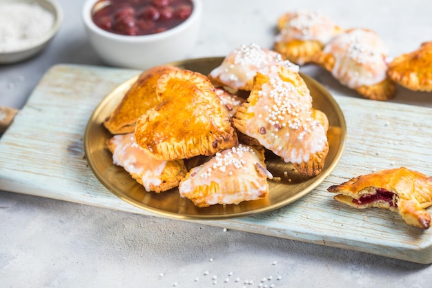 Strawberry heart pop tarts, shot from the top on a  concrete  background. Tasty toaster pastry