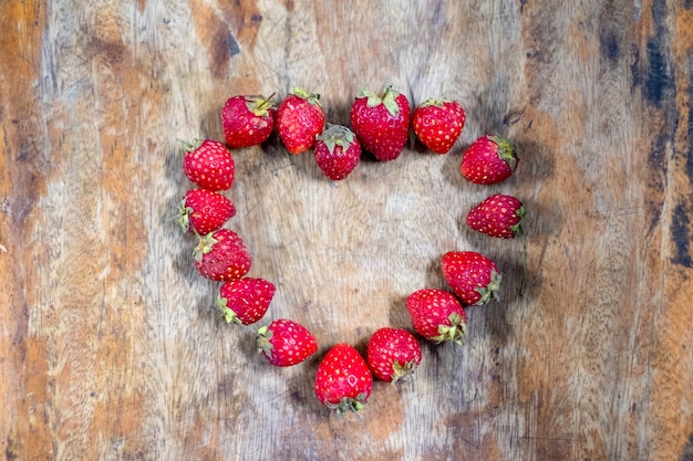 Strawberry heart shape design on wooden table Concept Valentine Day