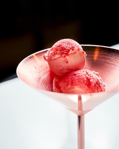 Strawberry ice cream in copper bowl closeup view