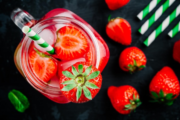 Strawberry iced cold drink with ice and mint Strawberry infused water cocktail lemonade or tea Top view