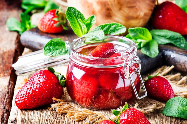 Strawberry jam vintage wood background selective focus