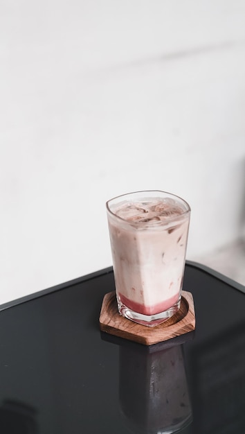 strawberry matcha latte with ice in the glass