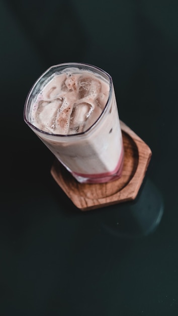 strawberry matcha latte with ice in the glass