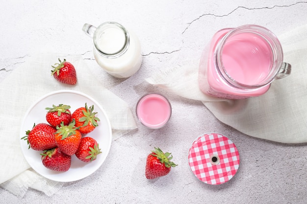 Strawberry Milk Shake Pitcher, strawberries and milk on white background