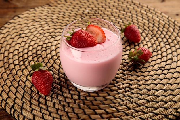 STRAWBERRY PANACOTTA served in a glass isolated on wooden background side view dessert