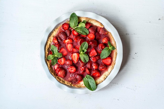 Strawberry pie round on a white surface top view