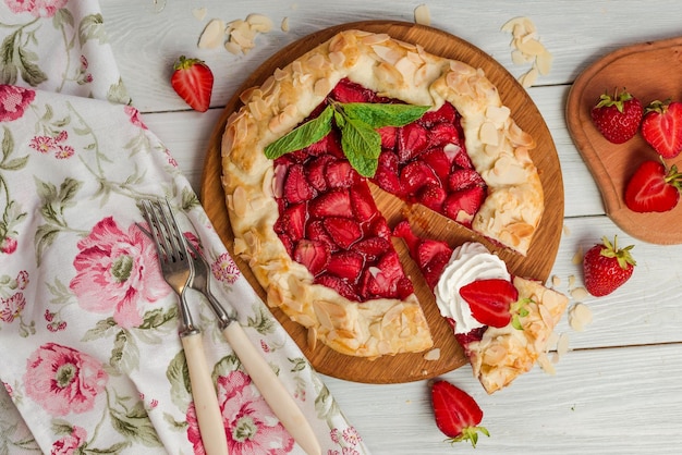 A strawberry pie with a slice taken out of it