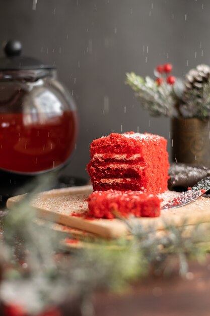 Strawberry piece of cake and red fruit tea with winter decorations