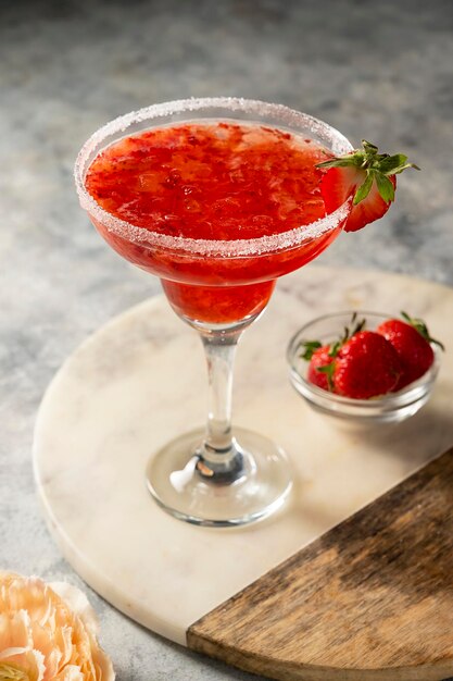 Strawberry refreshing margarita in tall footed glasse with fresh strawberries