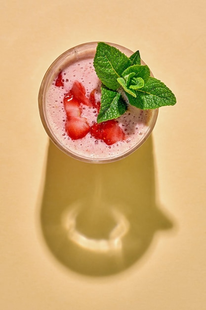 Strawberry smoothie on a bright background Cool drink or cocktail