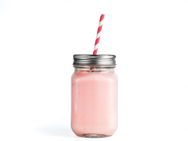 Strawberry smoothie in mason jar glass isolated