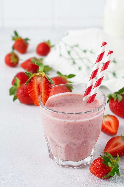 Strawberry smoothie or milkshake with berries and oatmeal in glass jar  