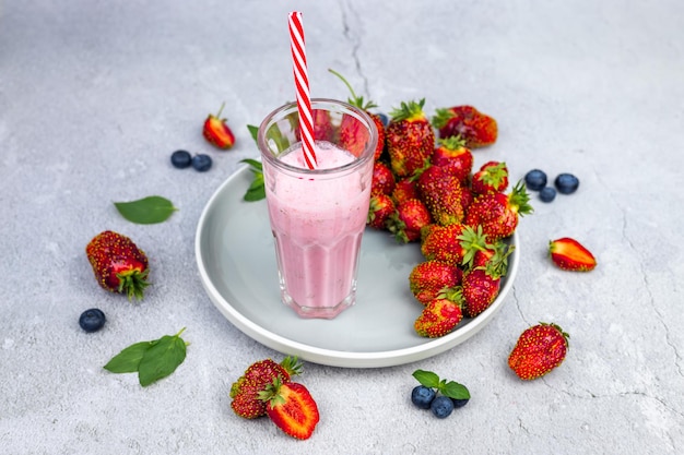 Strawberry smoothie Vegan smoothie or milkshake made with strawberries blueberries and mint Clean eating alkaline diet View from above