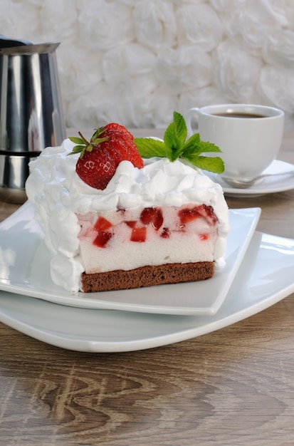 Strawberry souffle on a chocolate sponge cake with whipped cream