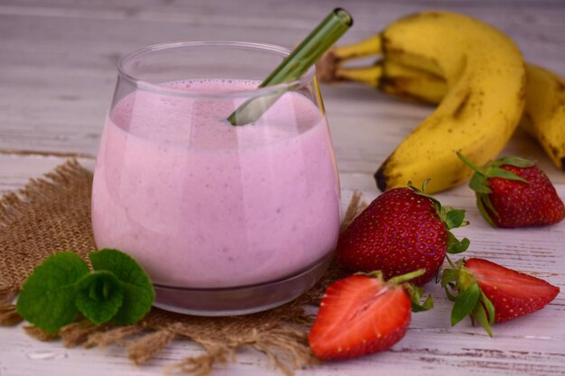 Strawberrybanana milkshake in a glass Closeup