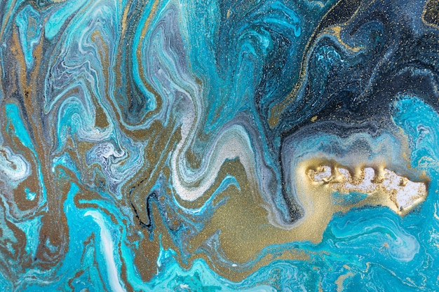 Streams of liquid blue white and gold ink curls waves of fluid turquoise and golden fluid paint