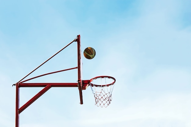 Street basketball ball ring board against the sky.