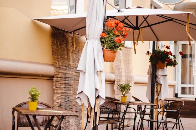 Street cafe in old town Empty tables and chairs Autumn city view Vintage style trendy neutral colors