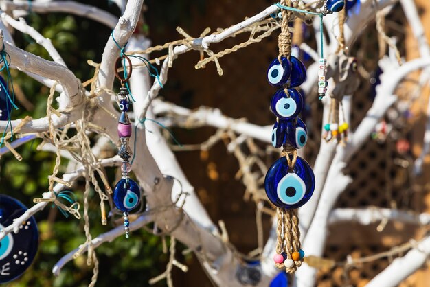 Street decorations in the form of a tree decorated with a large number of blue nazar stones from the evil eye against the blue sky