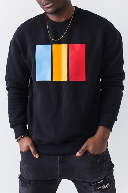 Street fashion concept - Studio shot of young handsome African man wearing sweatshirt against white background close-up.