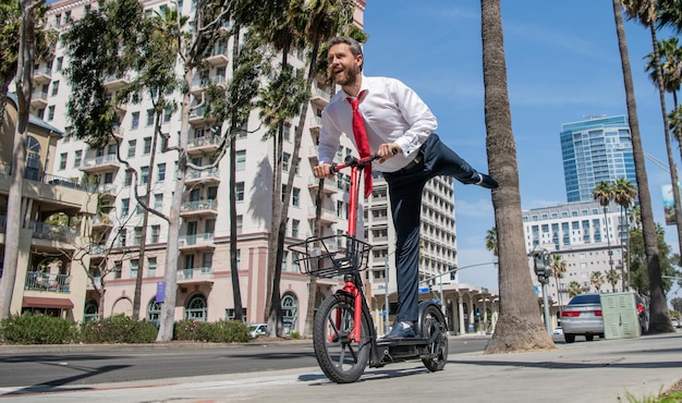 Street recreation Happy employer ride escooter on sidewalk Escooting for recreation and fun