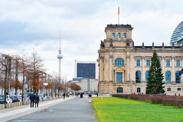 Street at Reichstag building with German Flag in Berlin, capital of Germany in winter in the street. German Bundestag parliament house.