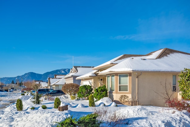 Street of residential houses in snow on winter sunny day