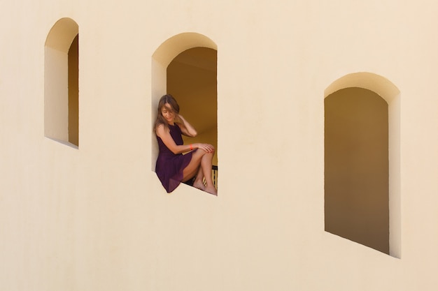 Street style outdoor portrait girl near building with three windows woman in egypt hotel copy space