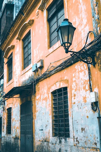 Street view on the beautiful old buildings with Portuguese style on old orange painted the facades . Macau China