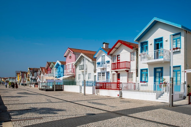 Street with colorful striped houses typical of Costa Nova Aveiro Portugal