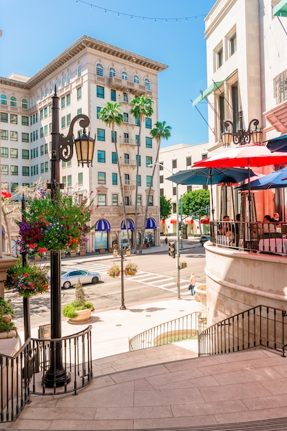 The streets of Beverly Hills shops among palm trees bright buildings in Los Angeles