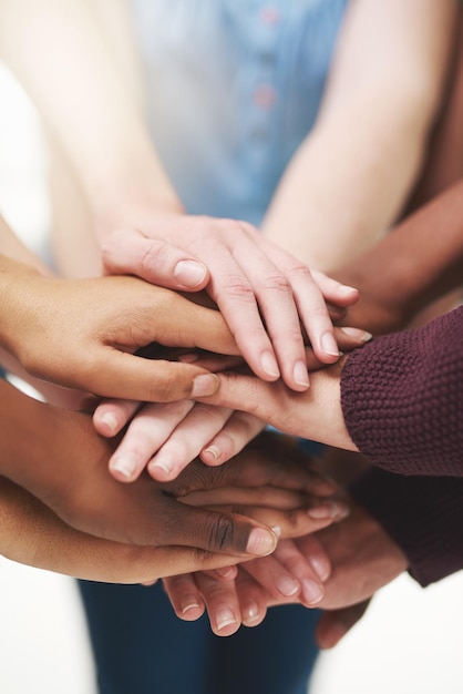 Strength in numbers Cropped shot of a group people putting their hands together in unity