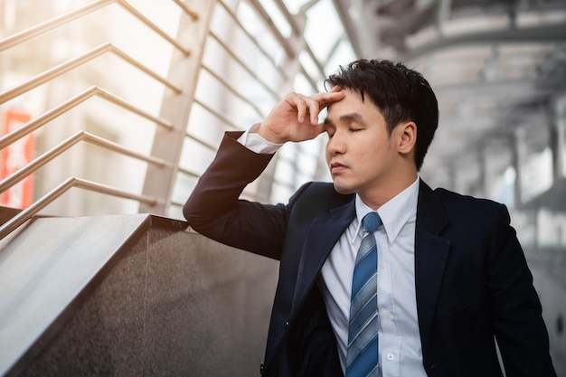 Stressed businessman in suit in the city