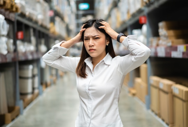 Stressed female manager in the warehouse store