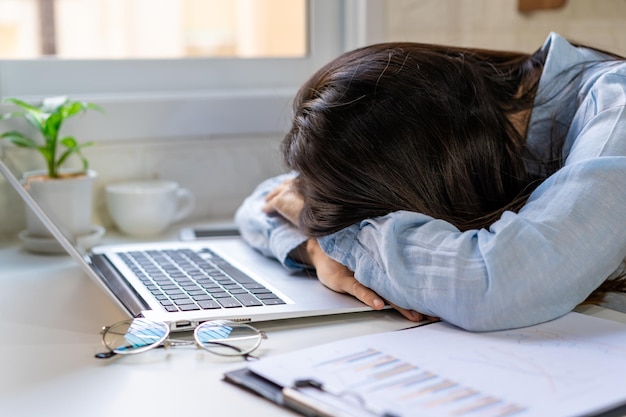 Stressed and frustrated asian business woman working with laptop in the office