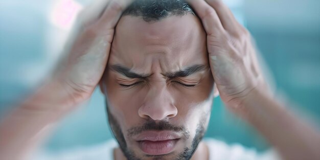 Stressed man holding head in blurry room showing signs of mental strain Concept Mental Health Stress and Anxiety Overwhelmed Coping Strategies Seeking Help